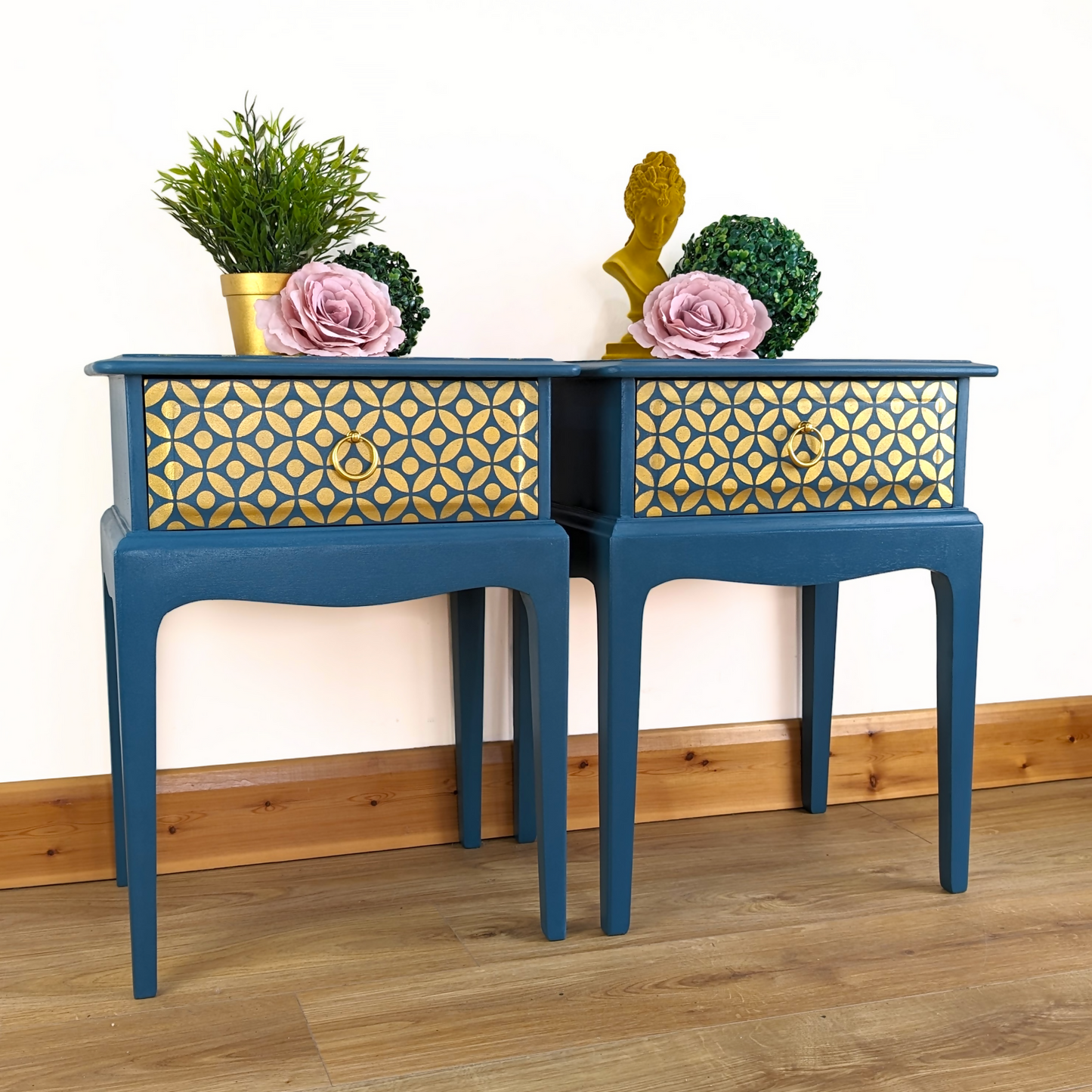 Pair of Stag Minstrel bedside cabinets, 'leggy' mid-century design with single drawers, painted in a teal blue with gold stencil detailing