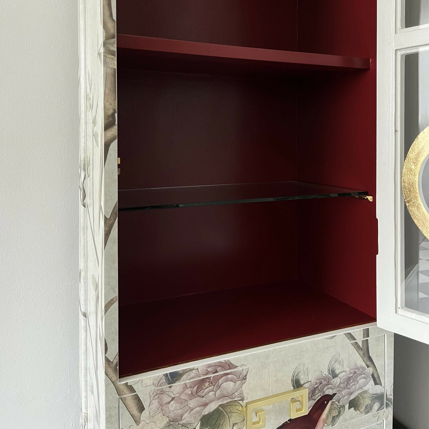 red painted inside of vintage chinoiserie display cabinet with glass shelves