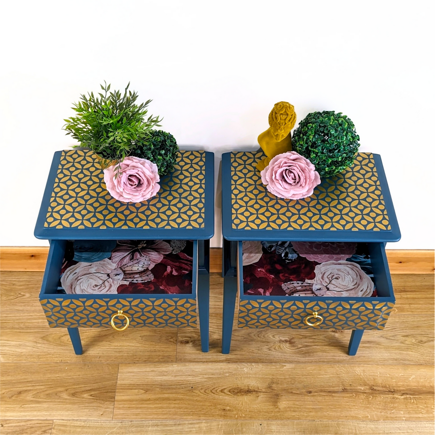 Pair of Stag Minstrel bedside cabinets, 'leggy' mid-century design with single drawers, painted in a teal blue with gold stencil detailing