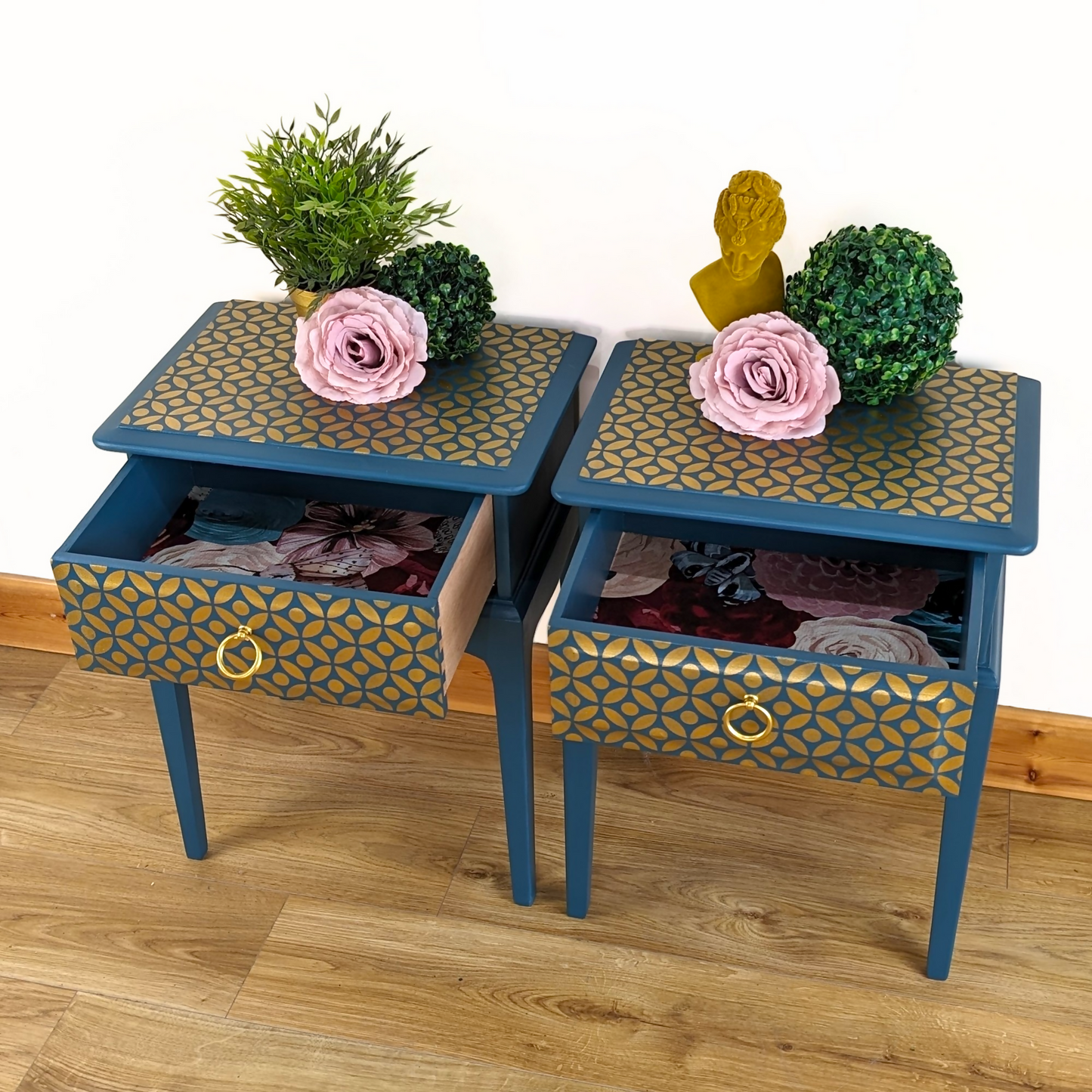 Pair of Stag Minstrel bedside cabinets, 'leggy' mid-century design with single drawers, painted in a teal blue with gold stencil detailing