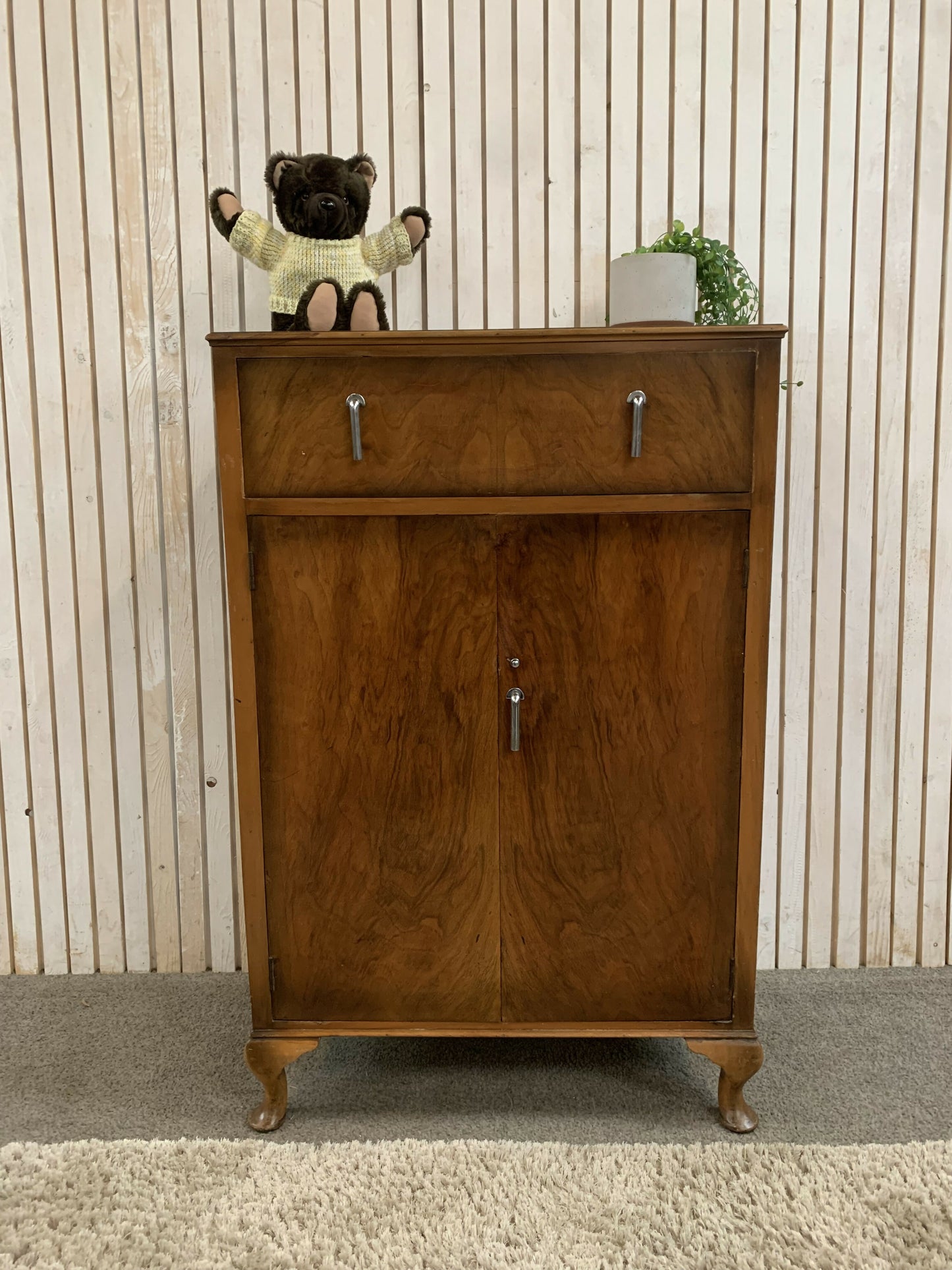 Vintage Art Deco burr walnut veneer cupboard featuring two doors and one drawer.