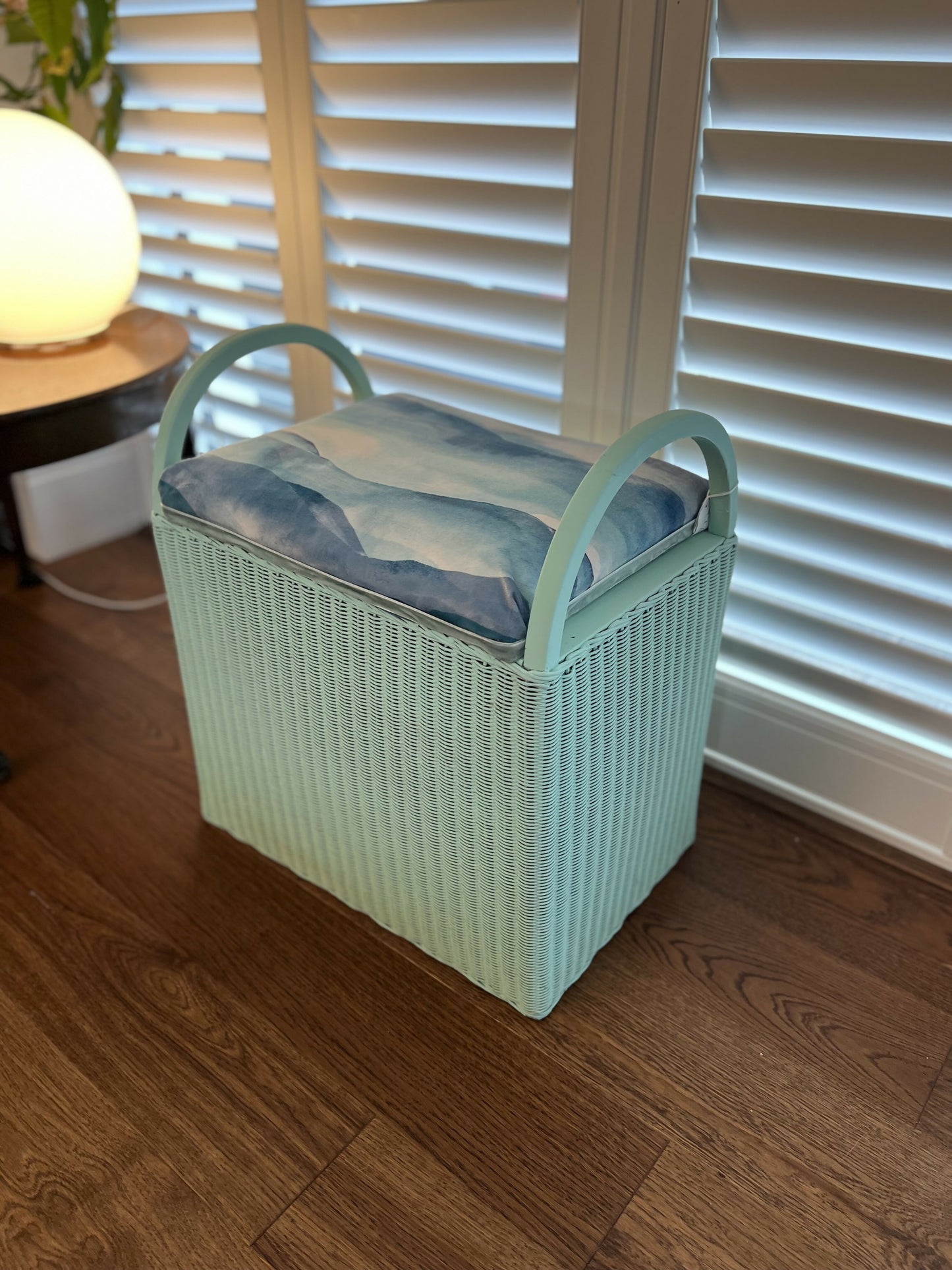 small green wave ottoman far