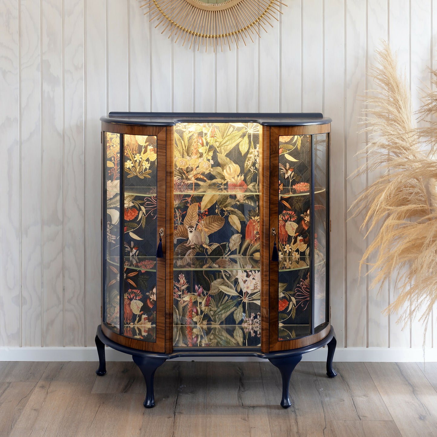 Professionally refinished Art Deco drinks cabinet, distinguished by its unique design and tropical jungle fabric. Sold, commission available.