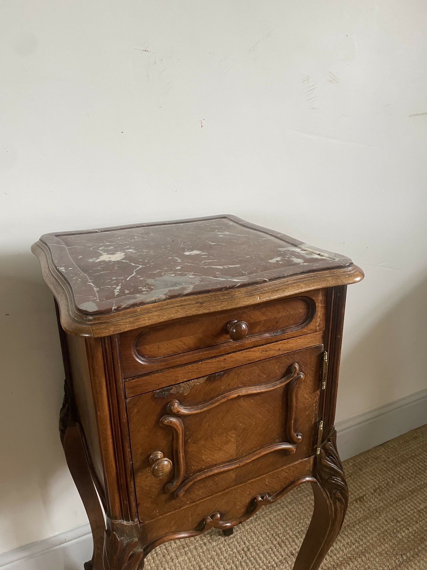 A near pair of antique French walnut and marble bedside tables
