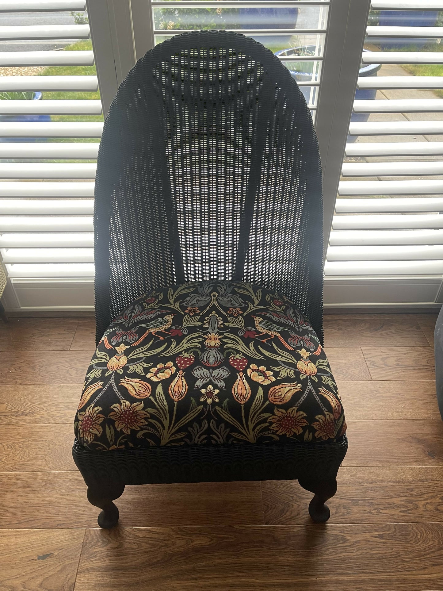 Lloyd loom low accent chair. Black satin paint and William morris style fabric