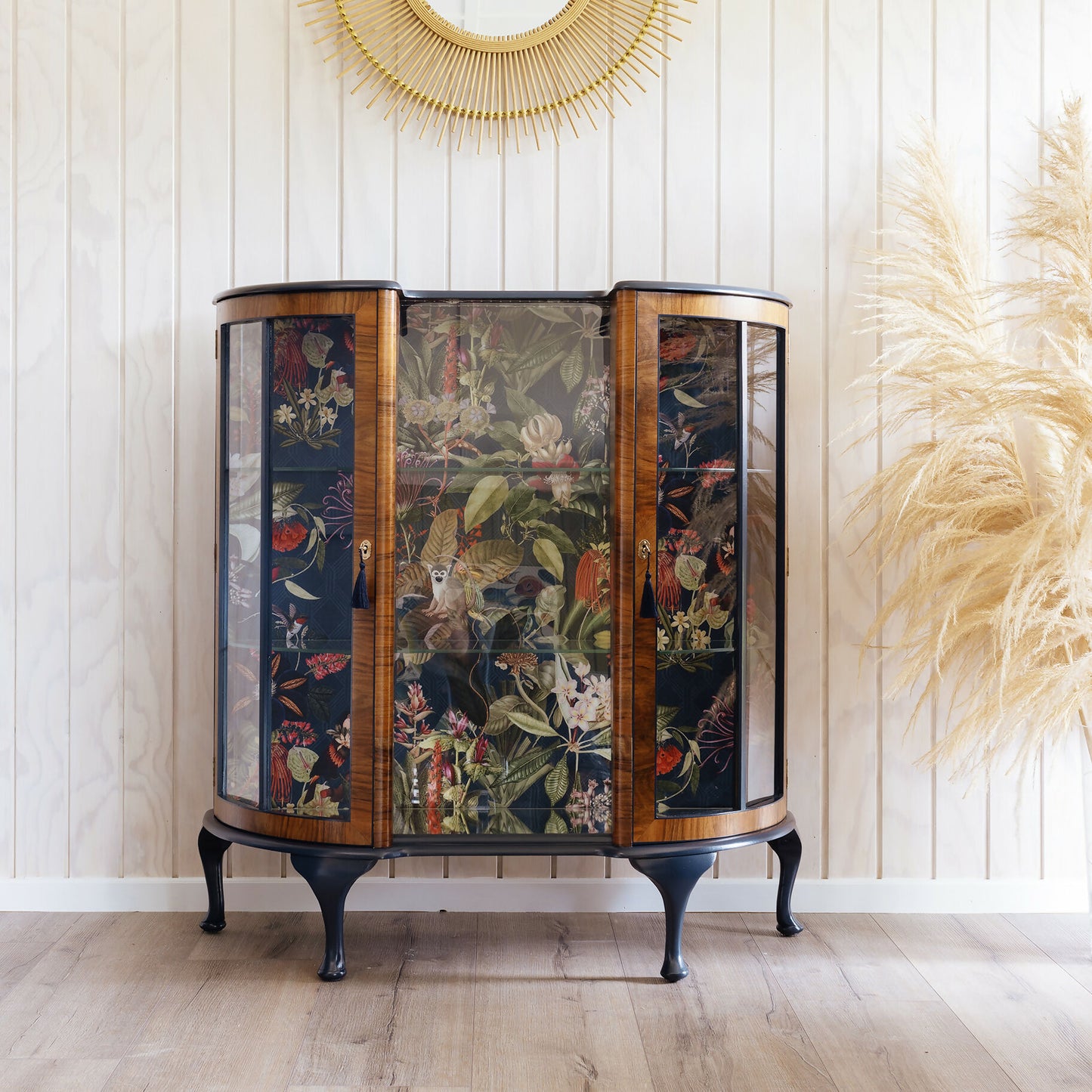 Professionally refinished Art Deco drinks cabinet, distinguished by its unique design and tropical jungle fabric. Sold, commission available.
