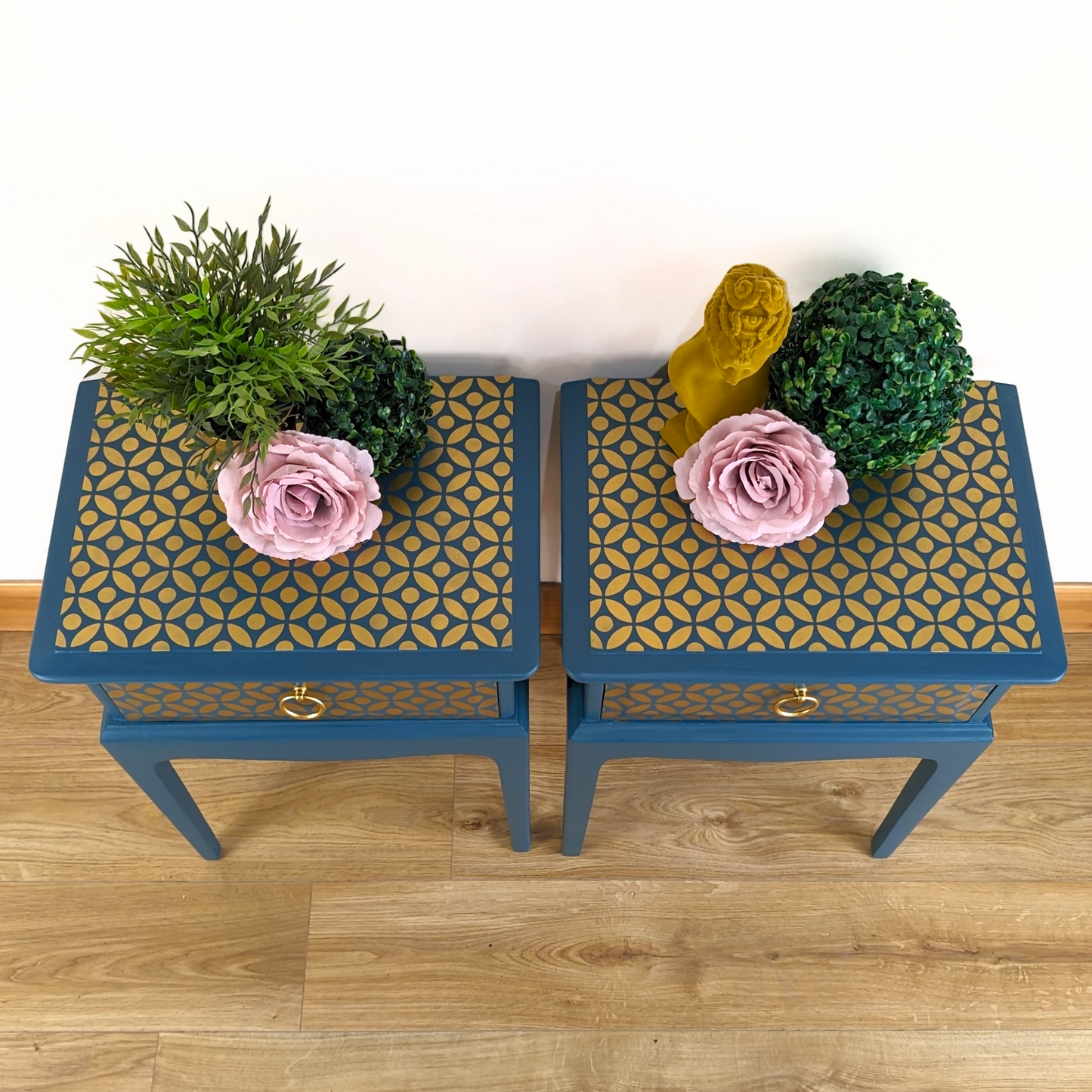 Pair of Stag Minstrel bedside cabinets, 'leggy' mid-century design with single drawers, painted in a teal blue with gold stencil detailing