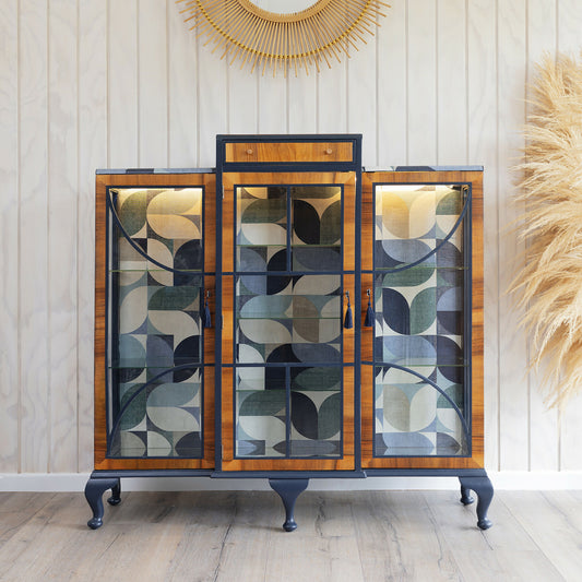 A beautiful Art Deco drinks cabinet, decoupaged in a striking blue Bauhaus fabric.