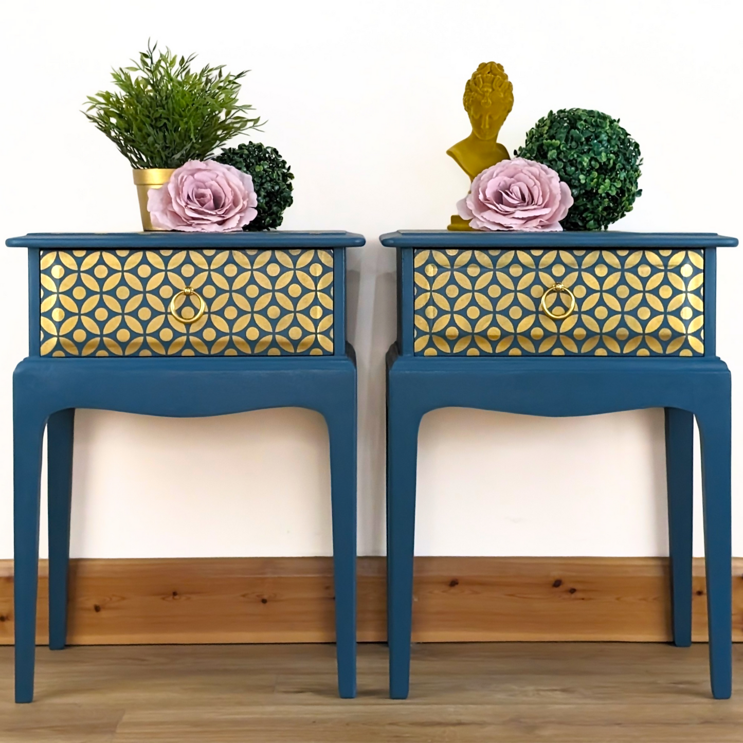 Pair of Stag Minstrel bedside cabinets, 'leggy' mid-century design with single drawers, painted in a teal blue with gold stencil detailing