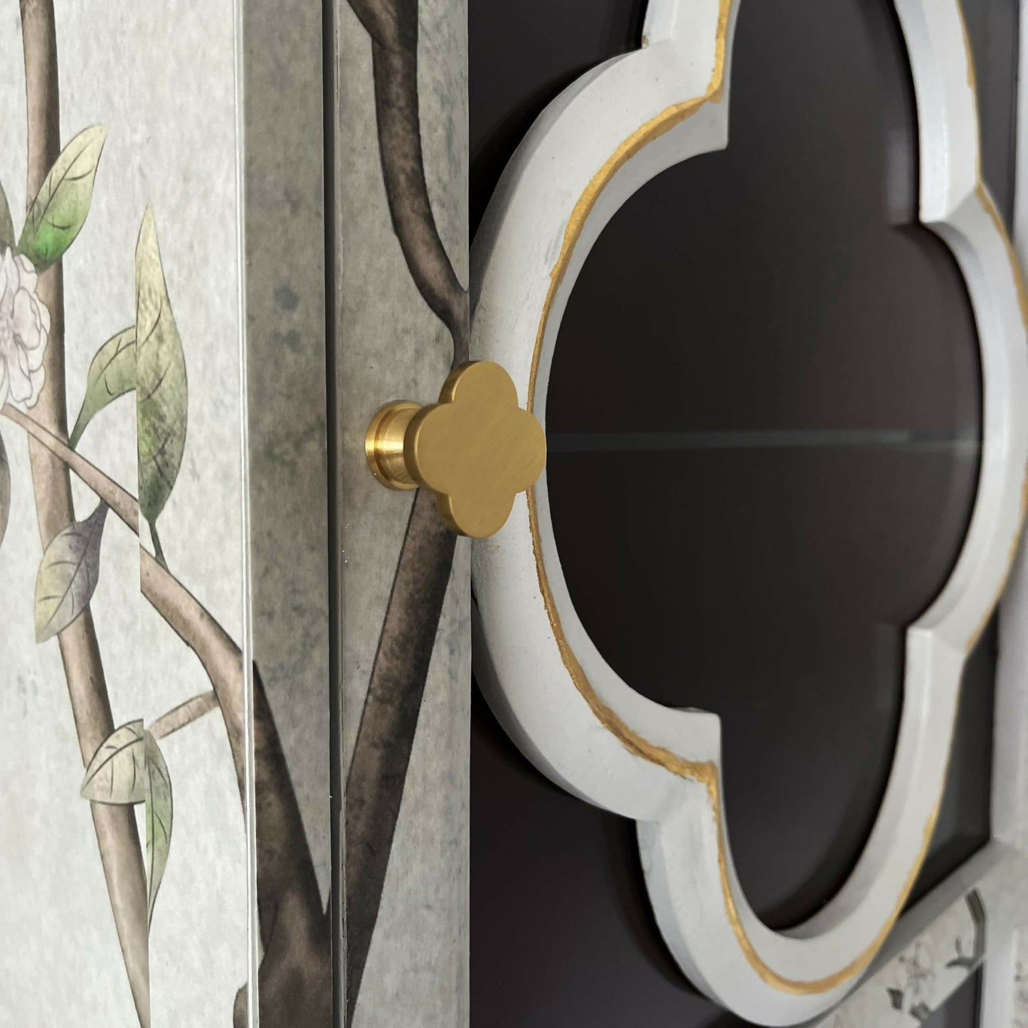 Clover shape bass handle on oriental cabinet with floral cabinet from close