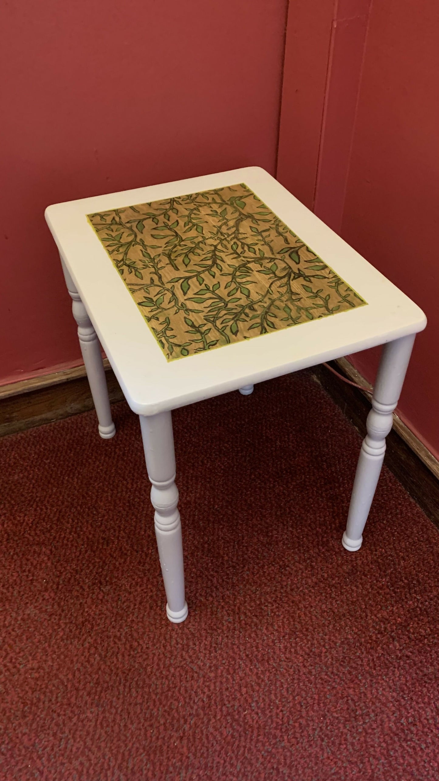 Light grey side table with hand-carved sage motif
