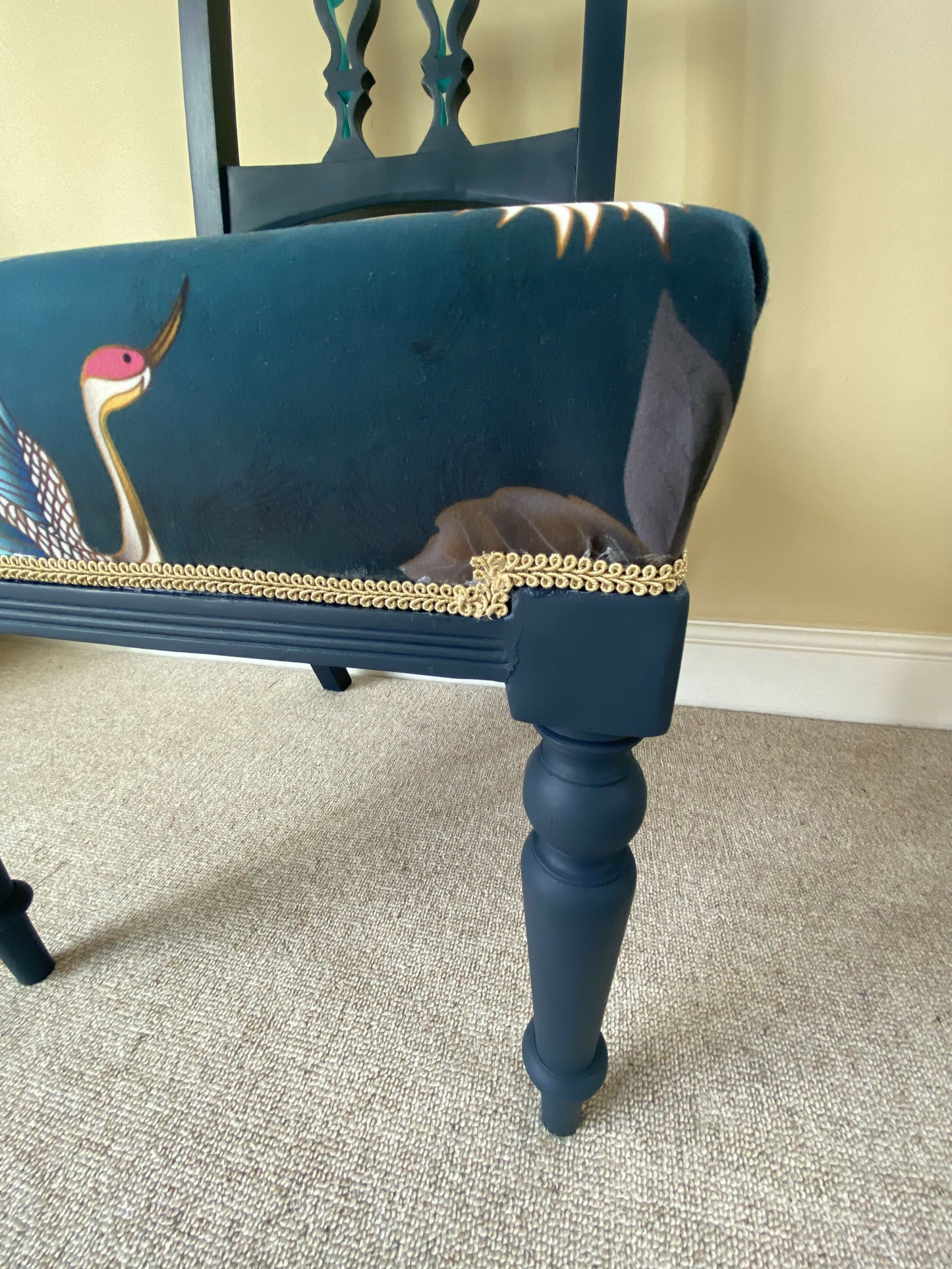 A blue painted high back vintage chair reupholstered in a turquoise blue crane and flower fabric
