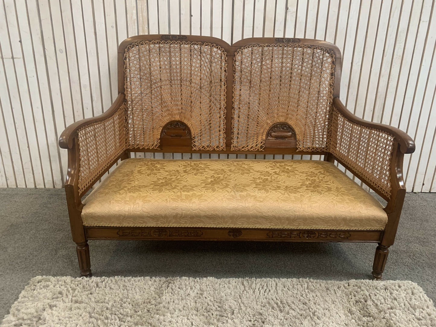Very attractive and unique antique gold-colored cane bergère two-seater sofa.