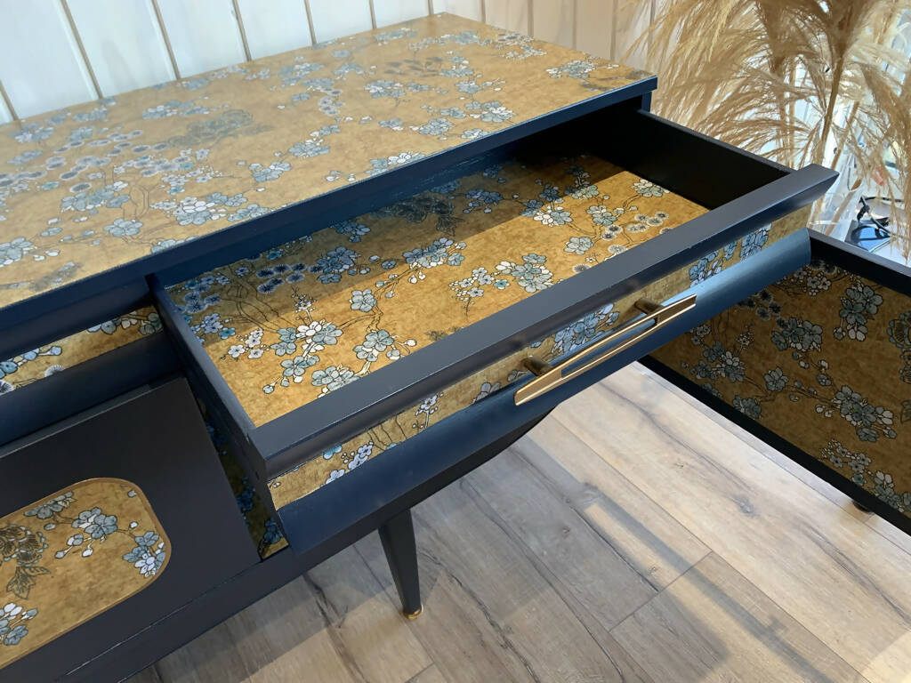 Blue mid century sideboard with an integrated cocktail bar, featuring a captivating blend of midnight blue and oriental fabric. Sold, commission available.
