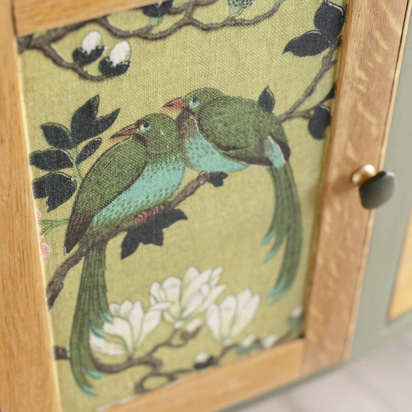 An exceptional vintage sideboard in a unique olive green hue, featuring an oval mirror and decoupaged in original Rockbird fabric. Sold: Commission Available.