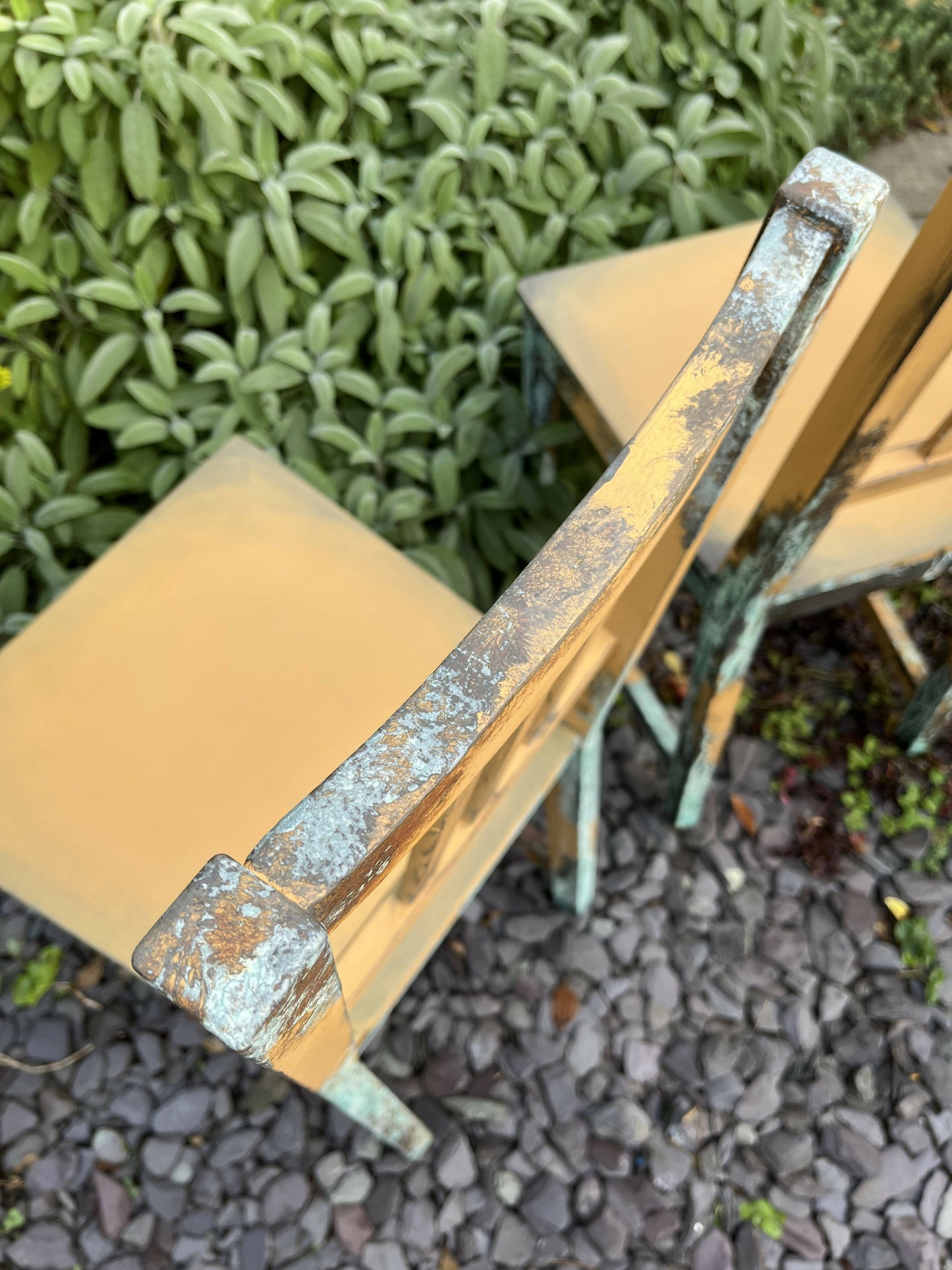 Two pumpkin and copper dining chairs