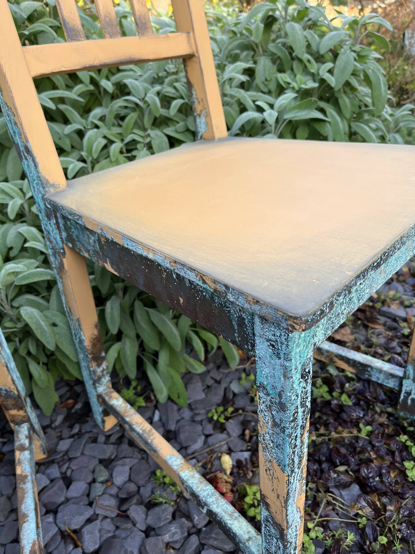Two pumpkin and copper dining chairs