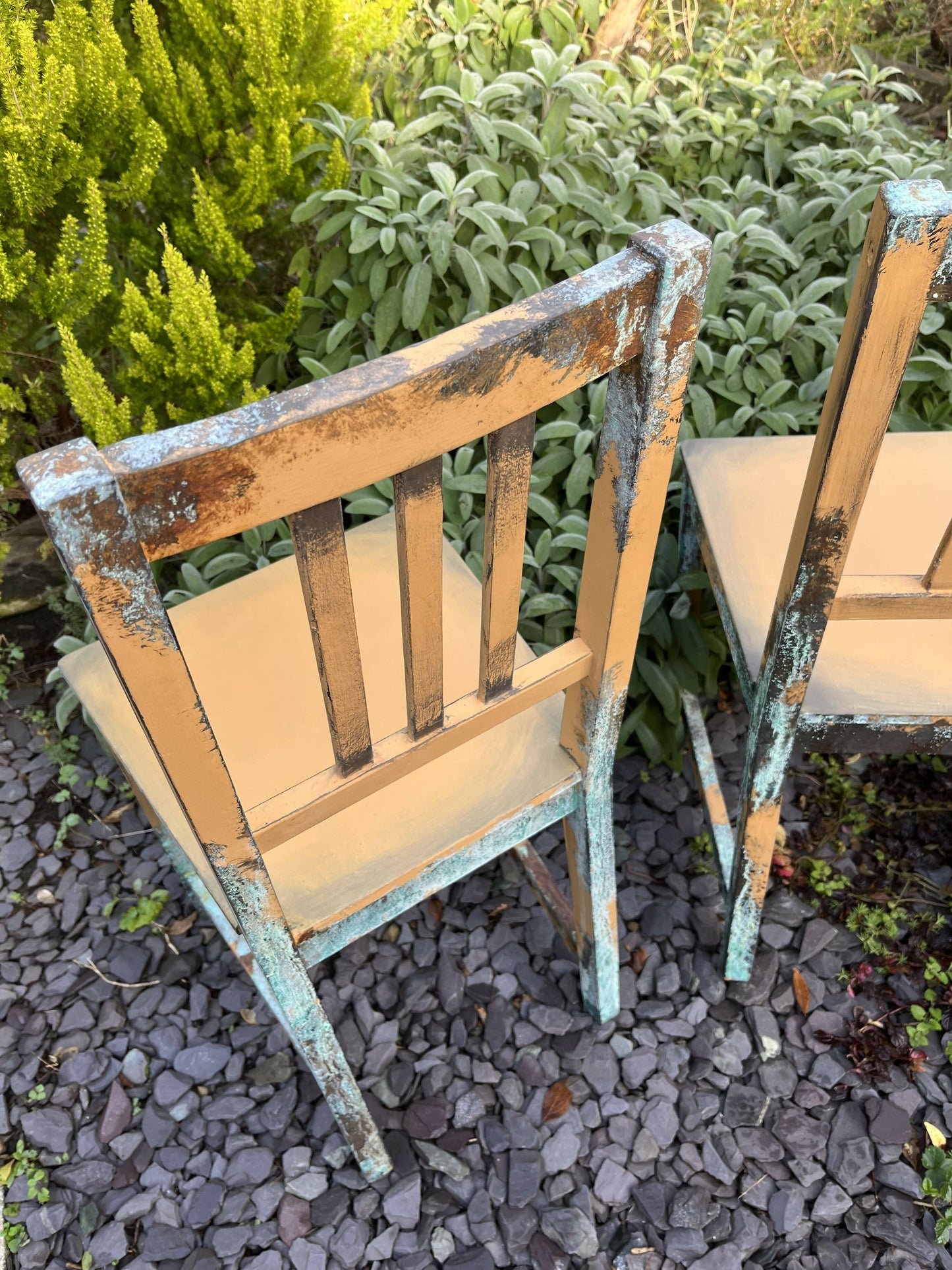 Two pumpkin and copper dining chairs