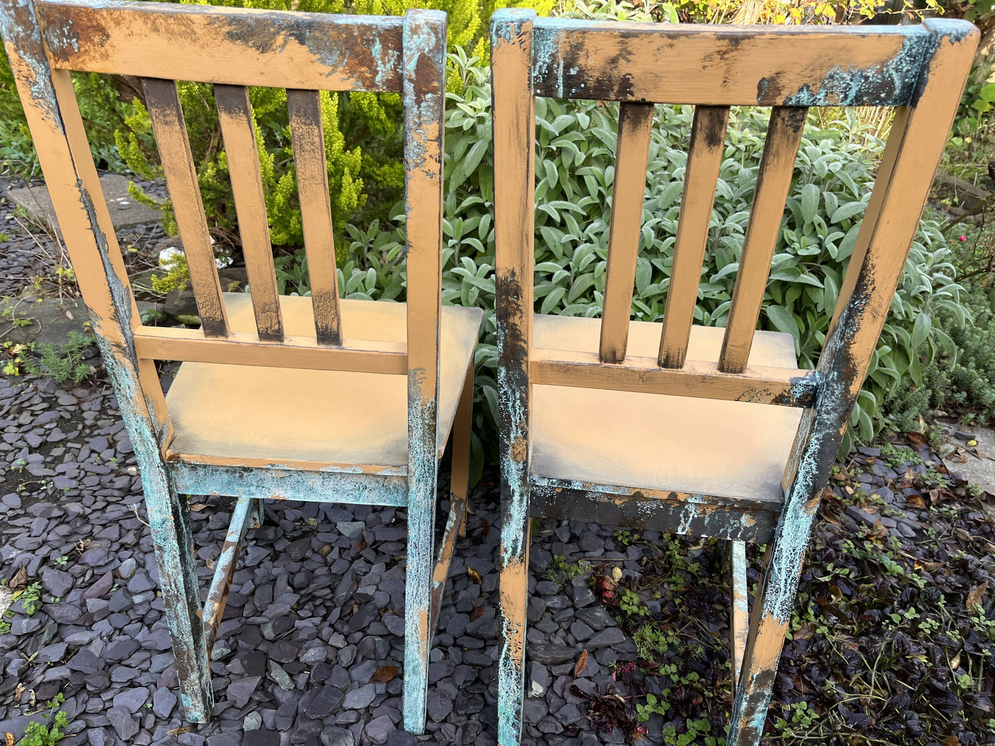 Two pumpkin and copper dining chairs