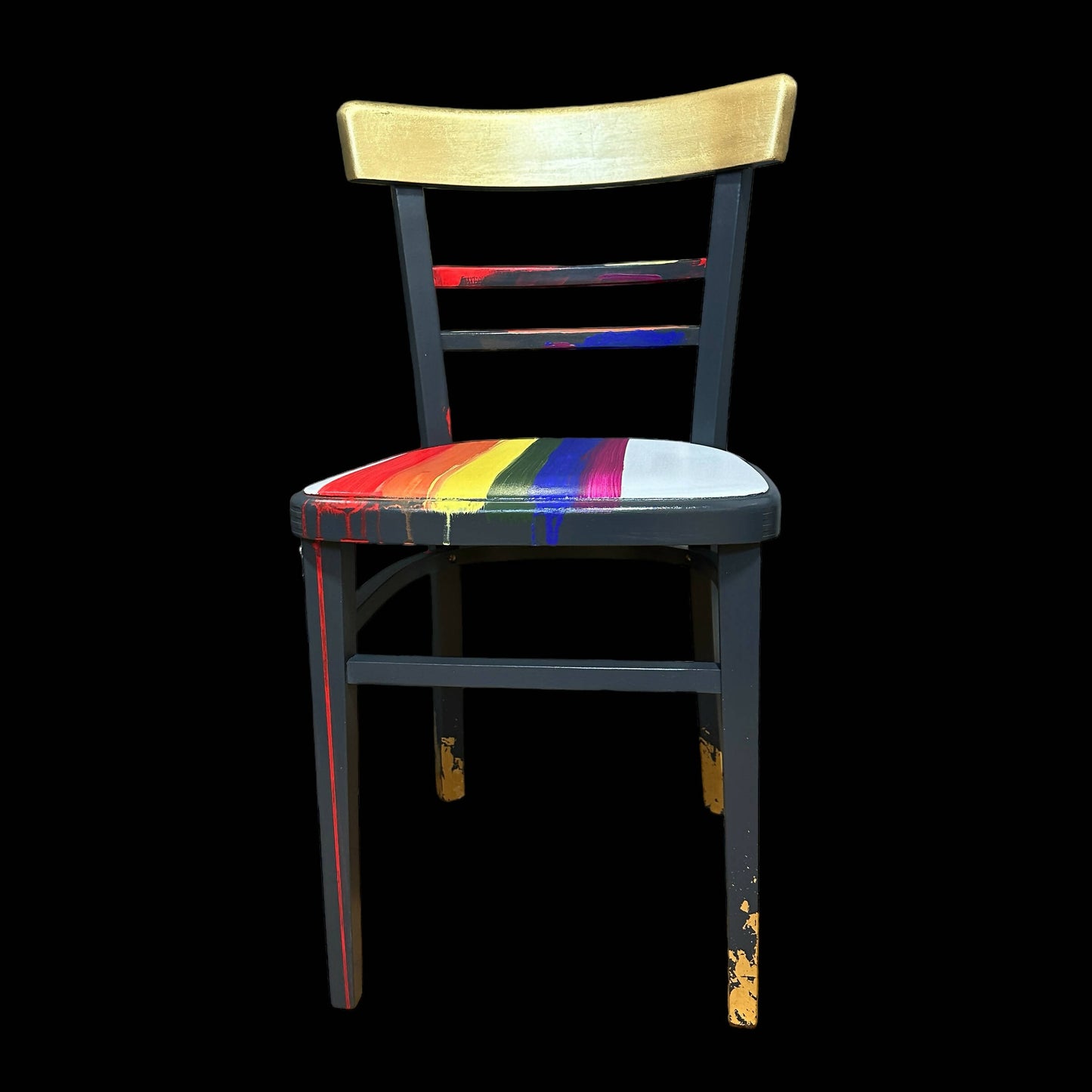 Hand painted school chair with vibrant rainbow stripe seat and gold leaf backrest. Abstract art design.