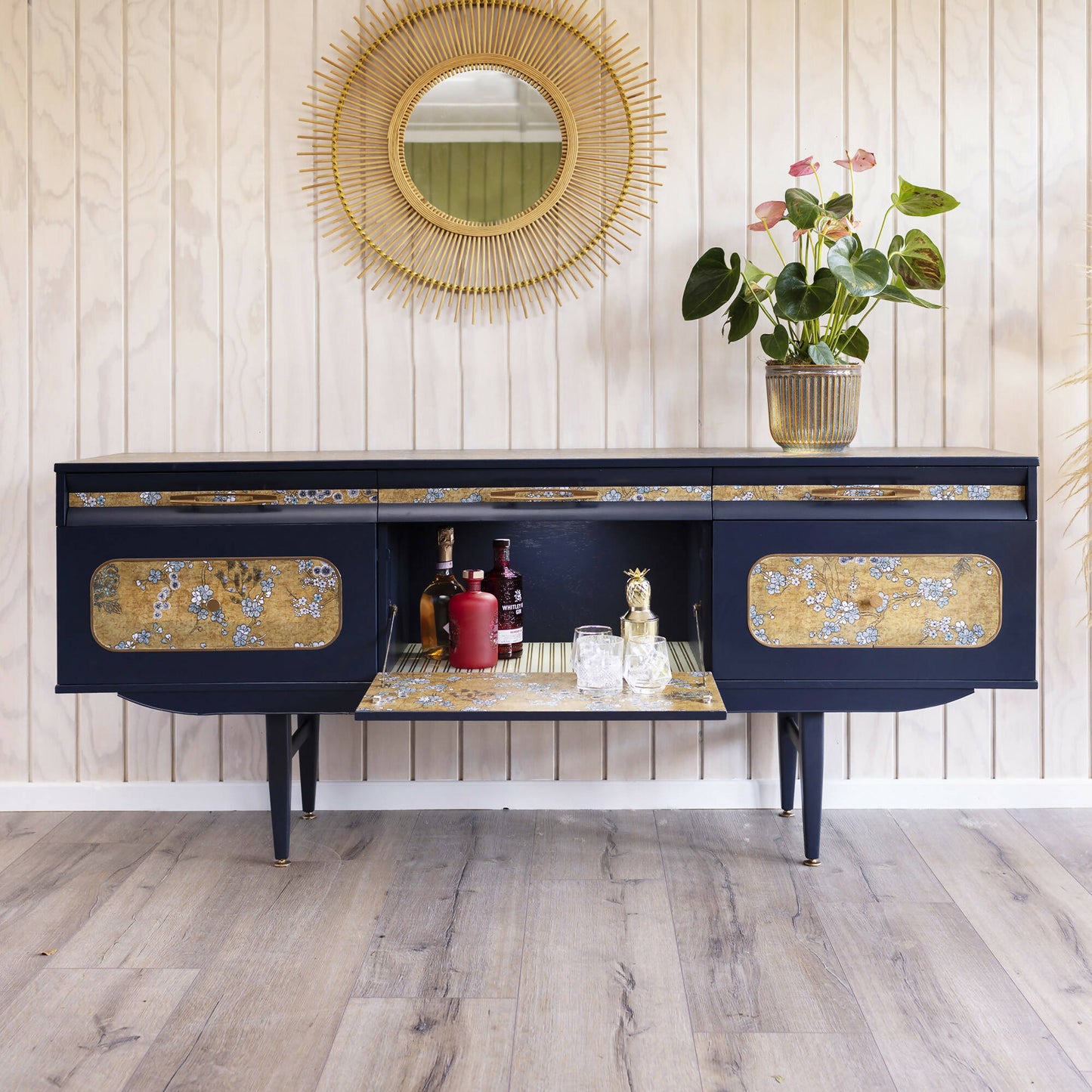 Blue mid century sideboard with an integrated cocktail bar, featuring a captivating blend of midnight blue and oriental fabric. Sold, commission available.