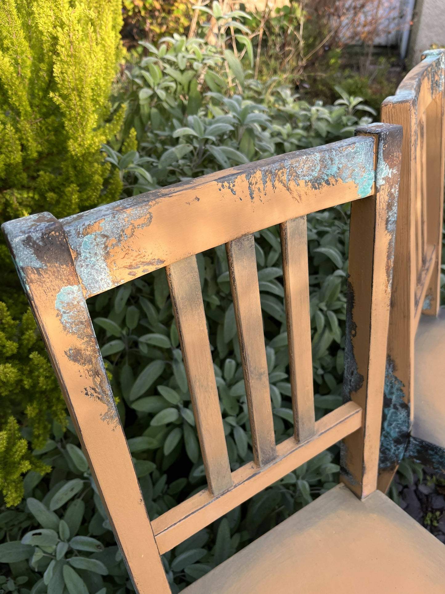 Two pumpkin and copper dining chairs