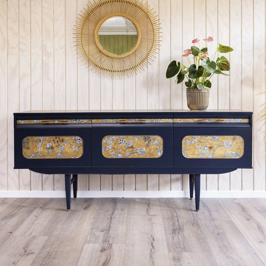 Blue mid century sideboard with an integrated cocktail bar, featuring a captivating blend of midnight blue and oriental fabric. Sold, commission available.