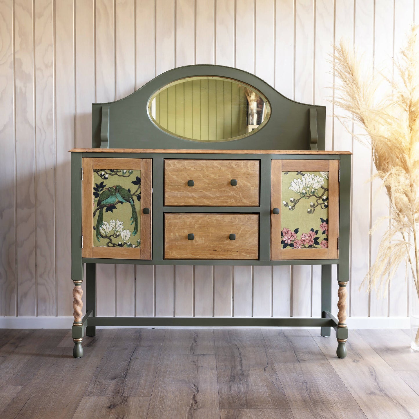 An exceptional vintage sideboard in a unique olive green hue, featuring an oval mirror and decoupaged in original Rockbird fabric. Sold: Commission Available.