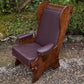 A NIGEL RUPERT GRIFFITHS MONASTIC CARVED OAK LEATHER FIRESIDE CHAIR / ARMCHAIR