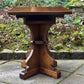A RUPERT GRIFFITHS MONASTIC CARVED SOLID OAK LAMP TABLE / PLANT STAND