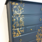 Refinished Stag Minstrel Tallboy Chest Of Drawers In Navy Blue With Gold Foil Floral Bird Design