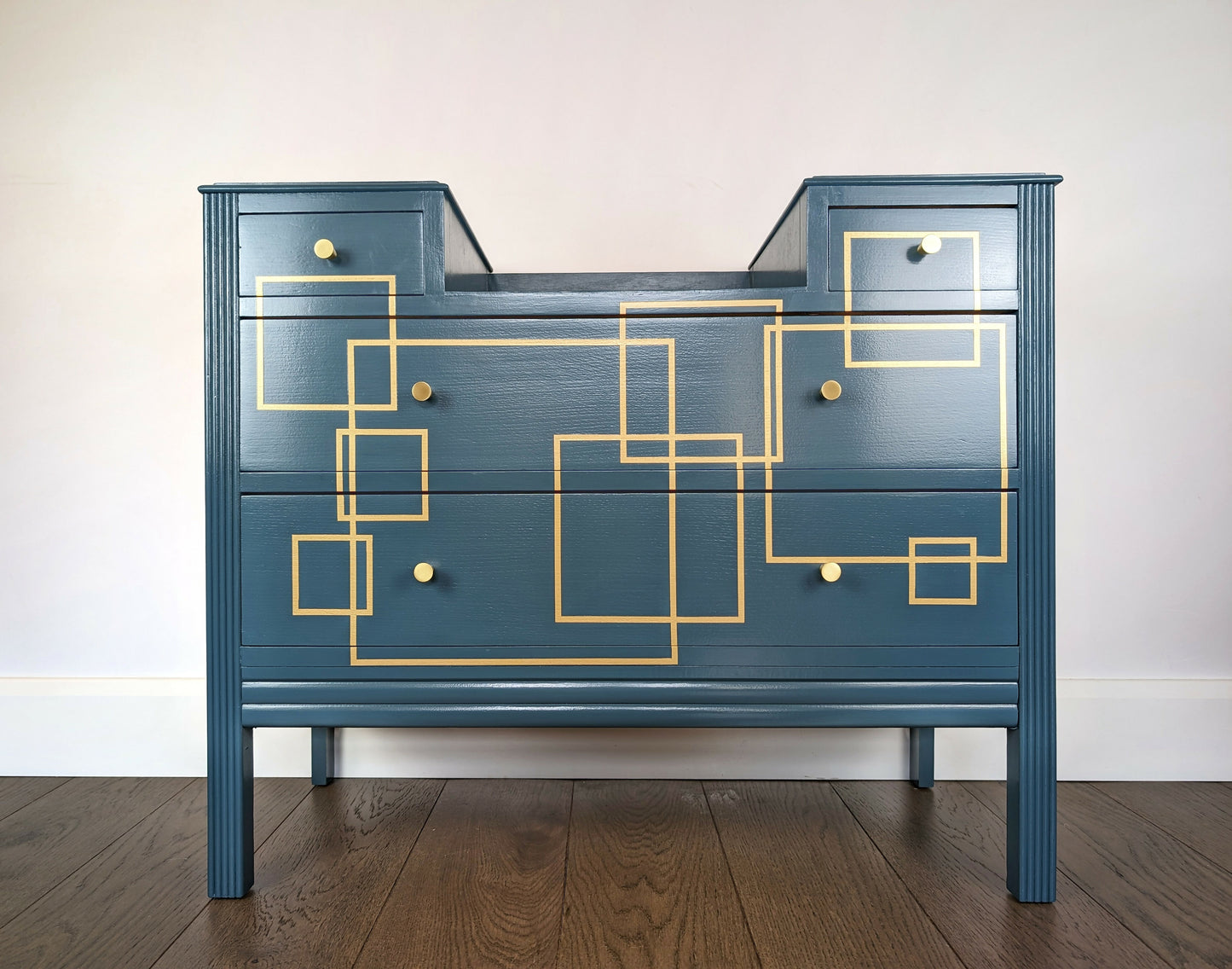 Blue and gold chest of drawers with geometric pattern and original mirrors