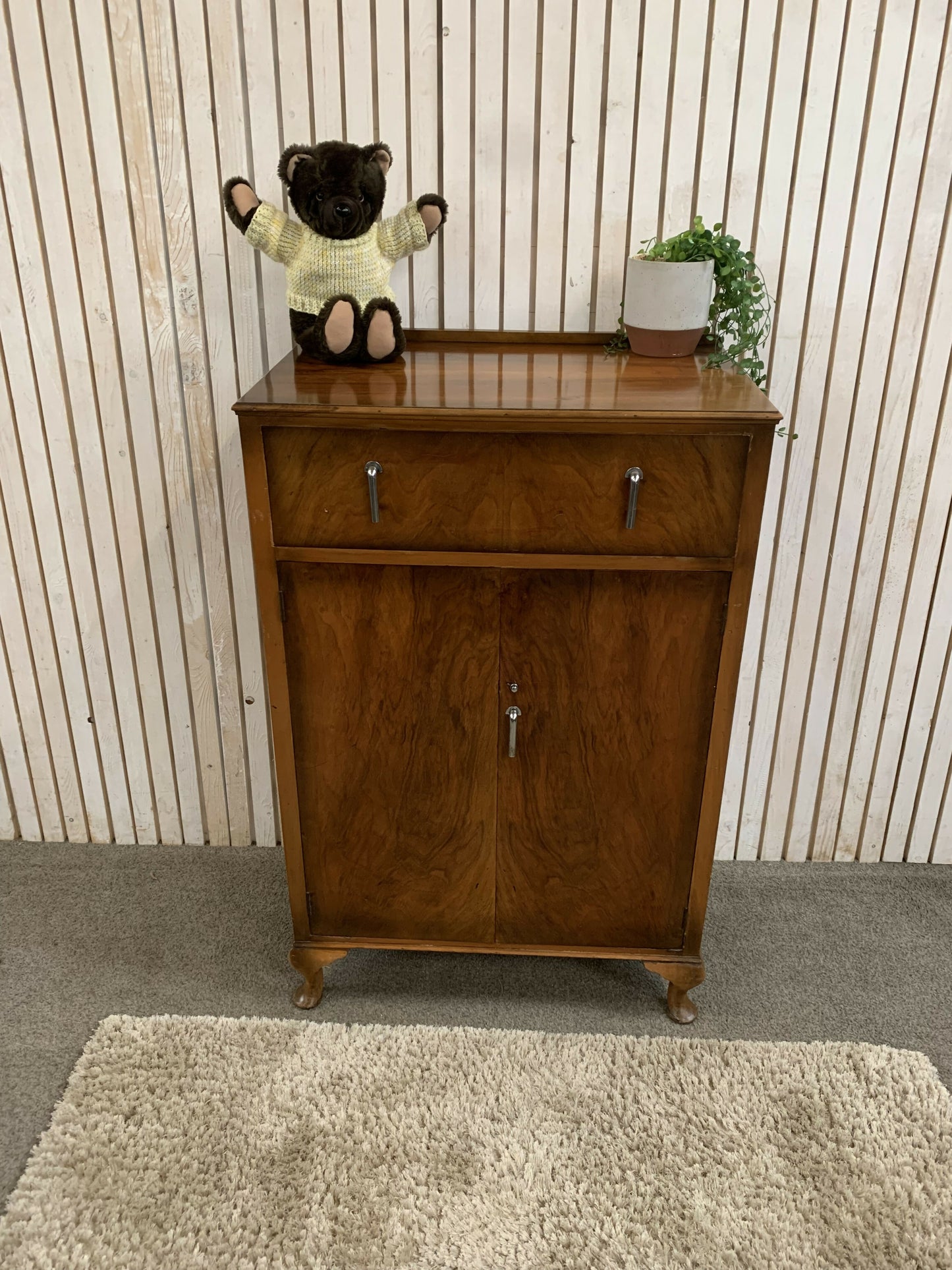 Vintage Art Deco burr walnut veneer cupboard featuring two doors and one drawer.