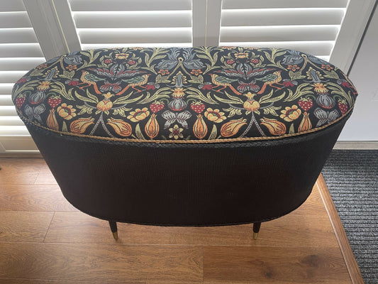 Black oval mid century modern ottoman - black paint William Morris style fabric