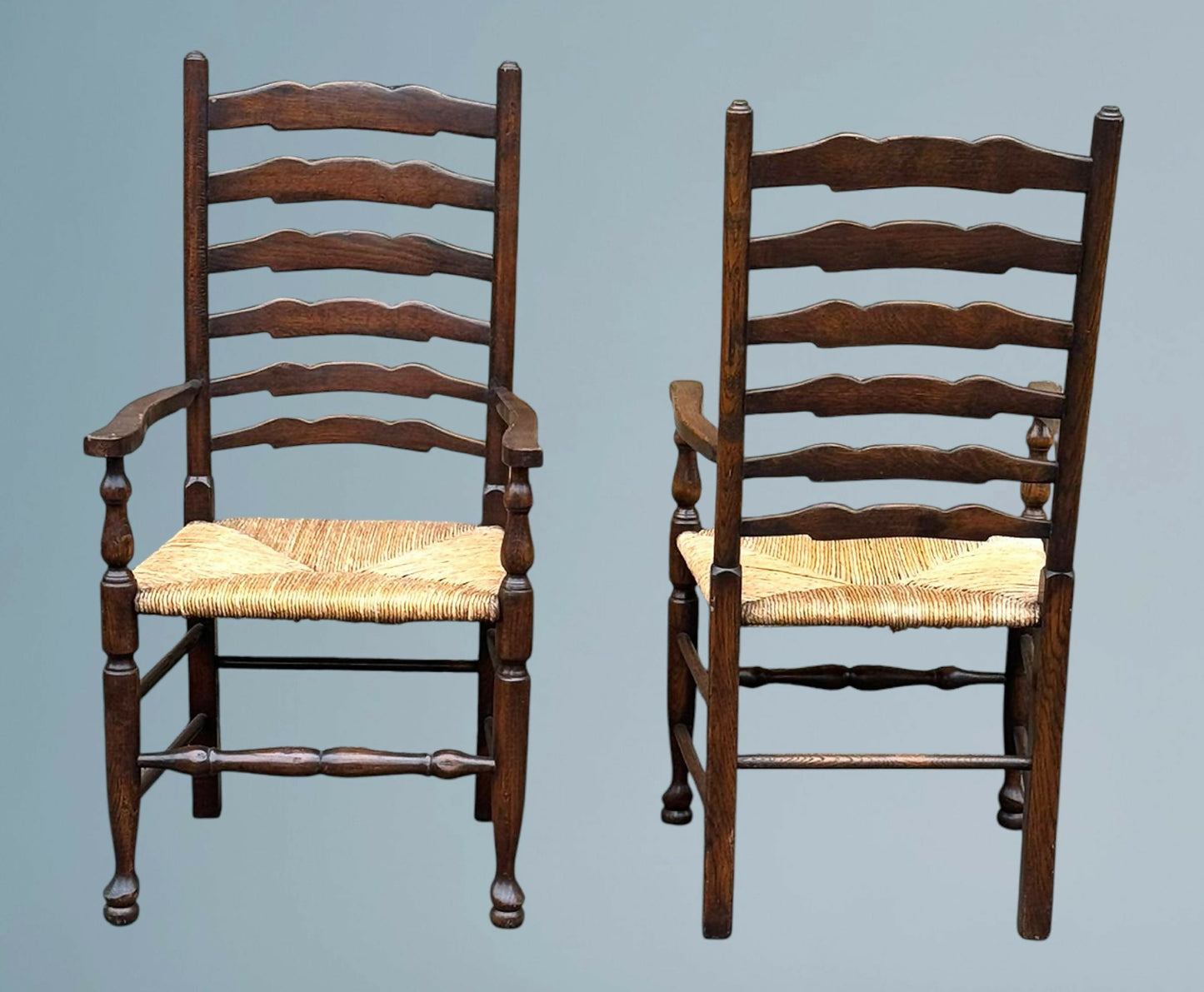 A Pair of Oak Ladder Back Rush Seated Armchairs