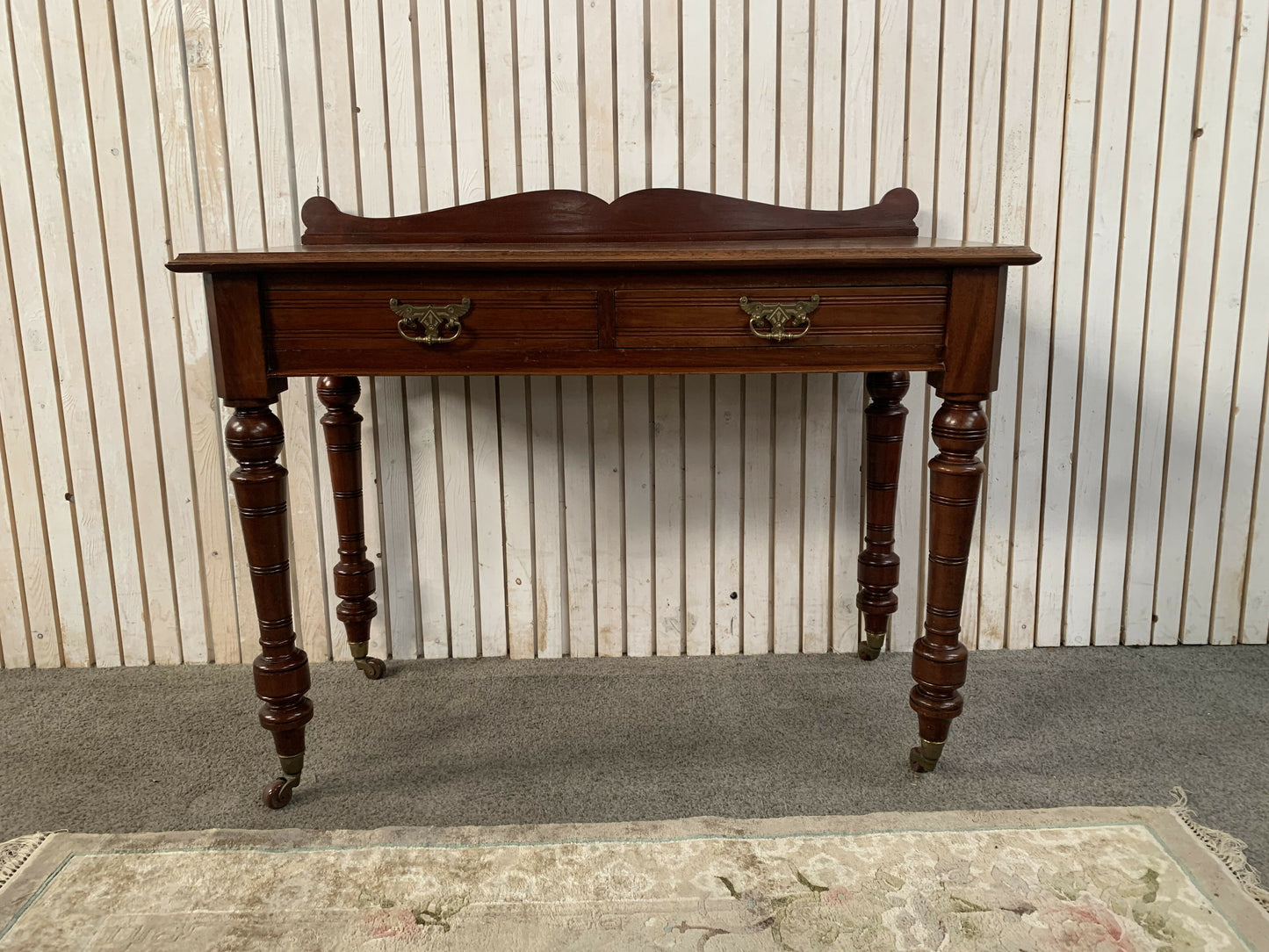 A Victorian Mahogany Writing Table/Desk With Drawer on castors.