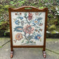 A RUPERT / NIGEL GRIFFITHS MONASTIC CARVED OAK FIRE SCREEN / STAND