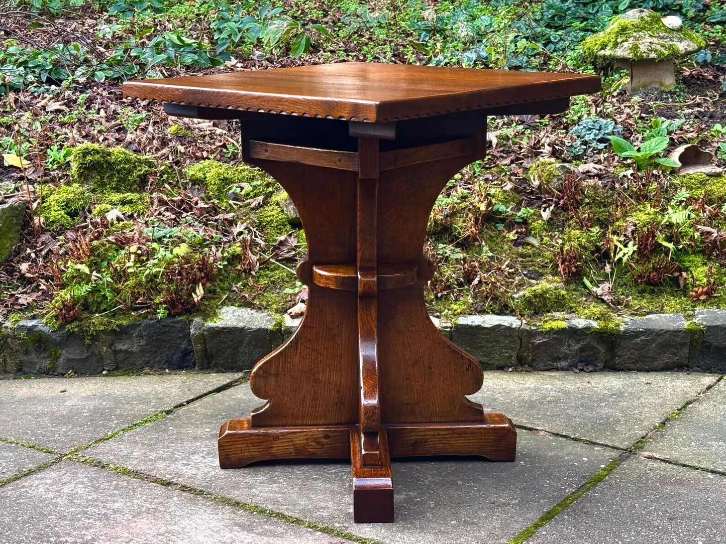 A RUPERT GRIFFITHS MONASTIC CARVED SOLID OAK LAMP TABLE / PLANT STAND