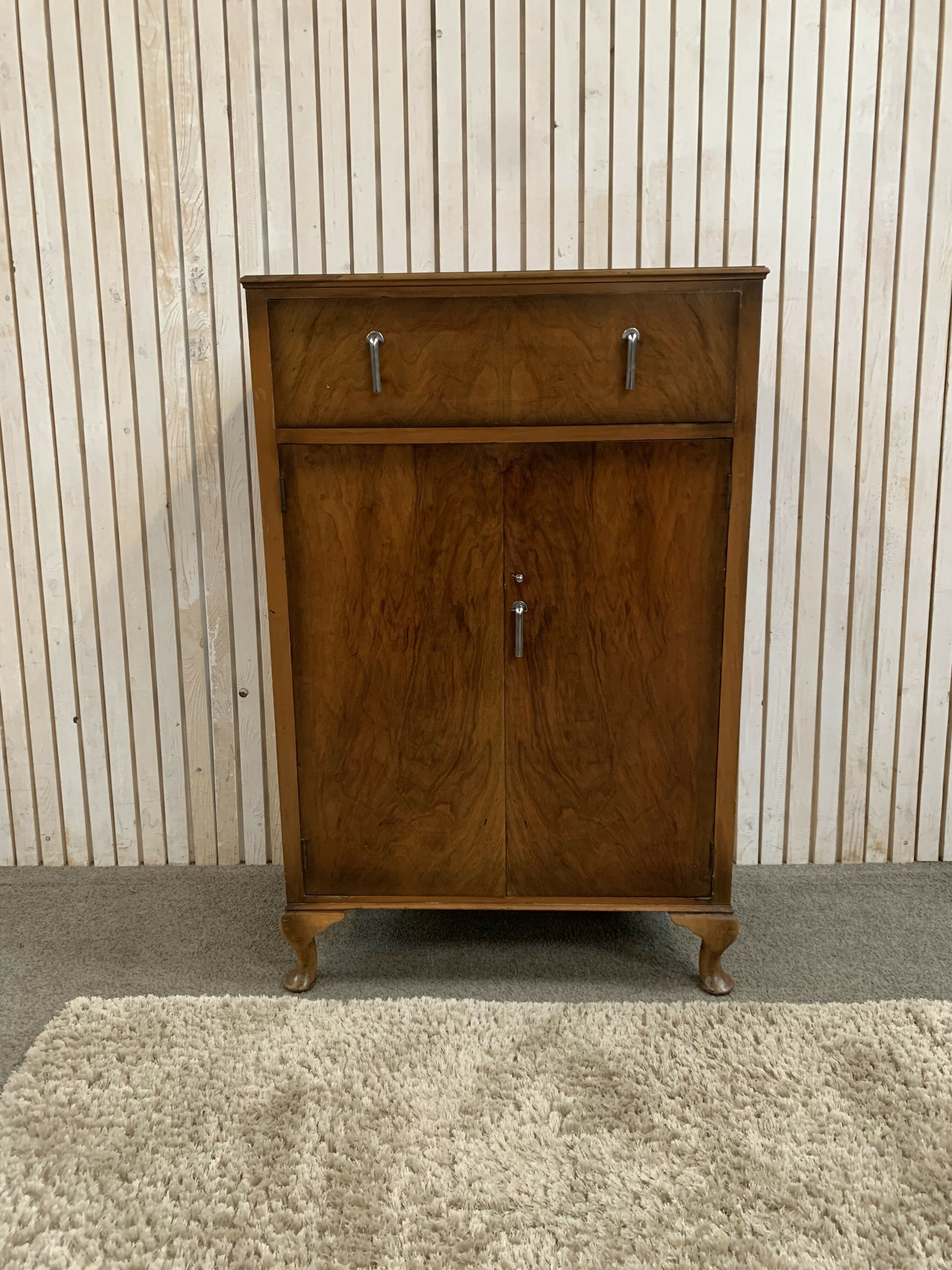 Vintage Art Deco burr walnut veneer cupboard featuring two doors and one drawer.