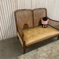 Very attractive and unique antique gold-colored cane bergère two-seater sofa.