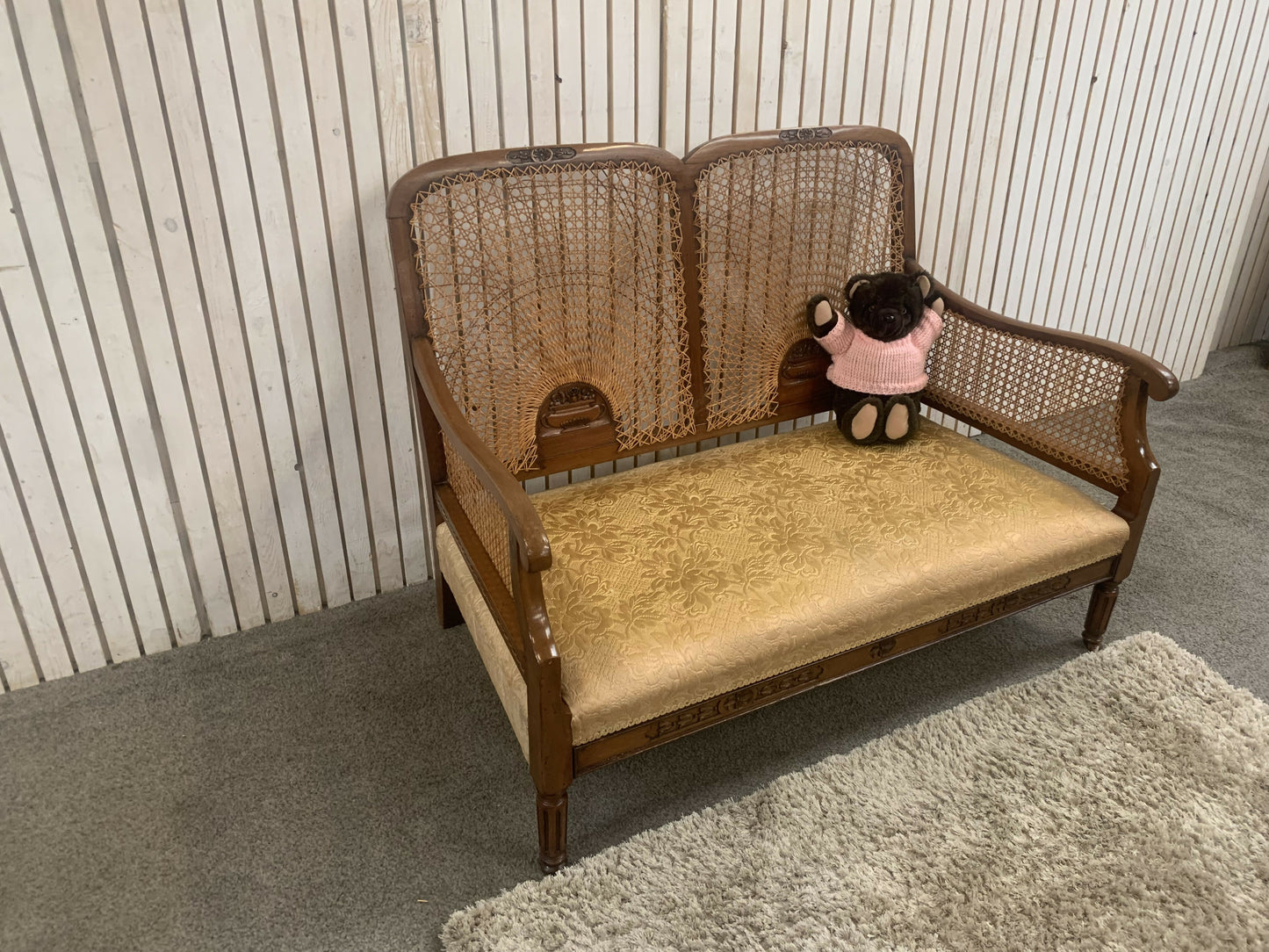 Very attractive and unique antique gold-colored cane bergère two-seater sofa.