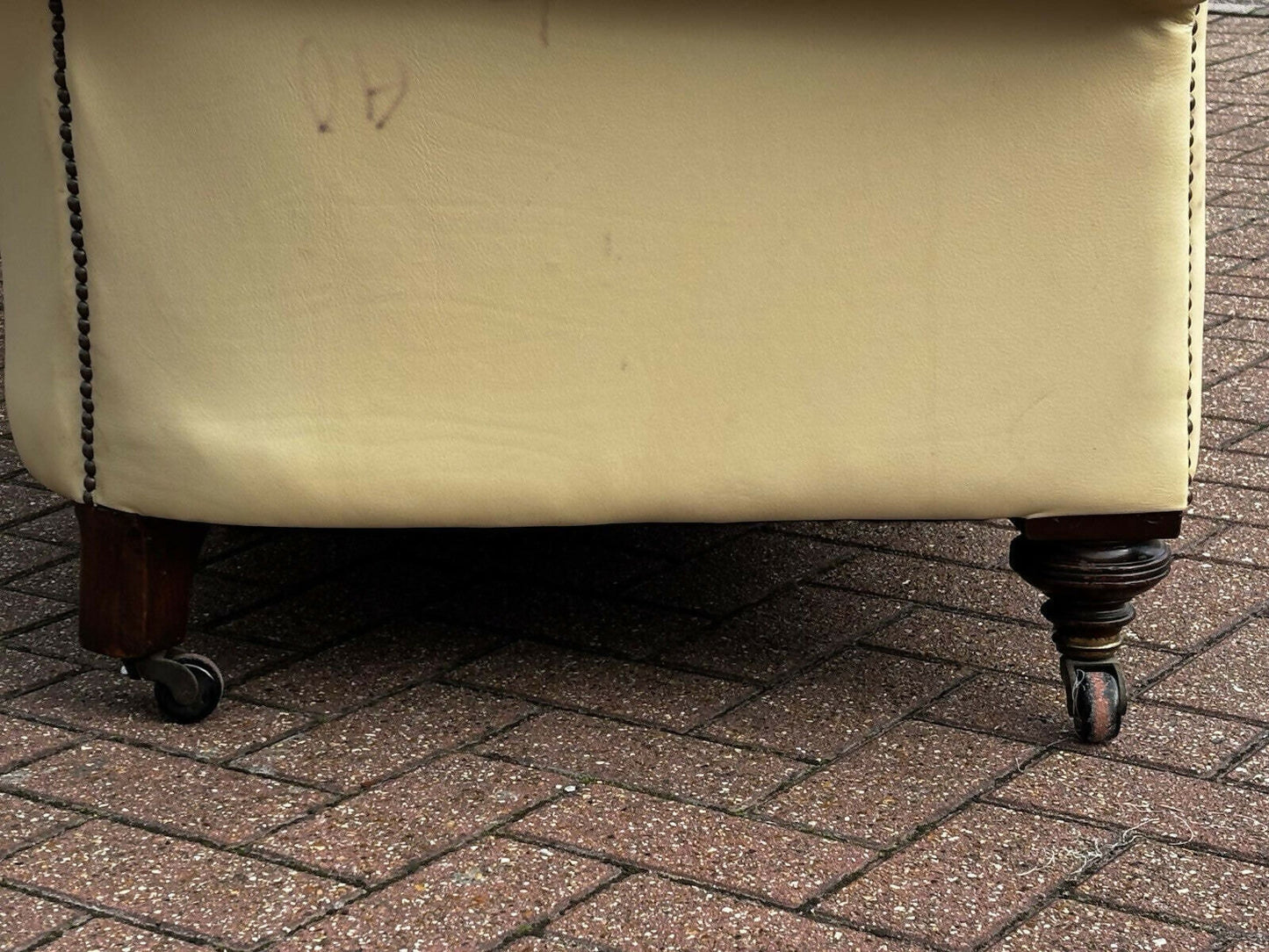 Vintage Victorian Buttoned Back Chesterfield Sofa In Leather On Brass Castors.