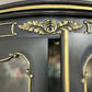 lose-up of gold detailing on French-style cabinet cornice