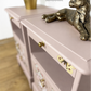 Dusky blush pink Stag Minstrel slim tea tray bedside tables with blossom and butterfly design. Nightstands pale pink