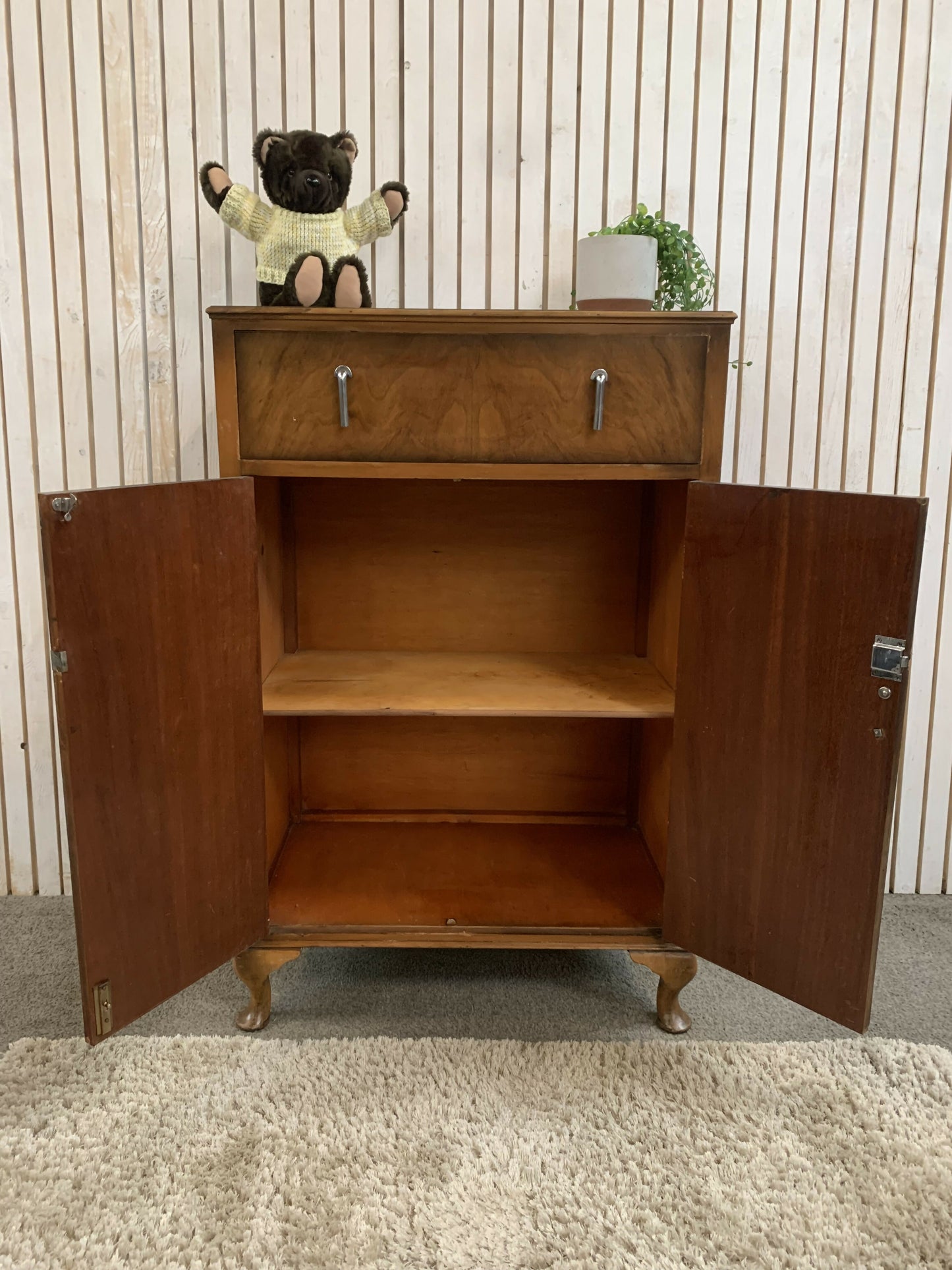 Vintage Art Deco burr walnut veneer cupboard featuring two doors and one drawer.