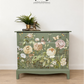 Sage green Stag Minstrel chest of drawers with neutral floral design. 3 over 2. Sideboard, dresser, bedside table
