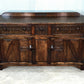 A NIGEL RUPERT GRIFFITHS MONASTIC CARVED OAK DRESSER BASE / SIDEBOARD / CABINET / CUPBOARD.