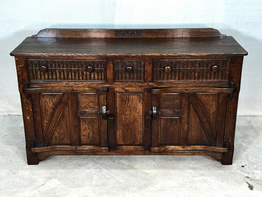 A NIGEL RUPERT GRIFFITHS MONASTIC CARVED OAK DRESSER BASE / SIDEBOARD / CABINET / CUPBOARD.