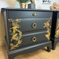 Matt Black Stag Minstrel bedside tables with gold floral and bird design. vintage nightstands. Teatray