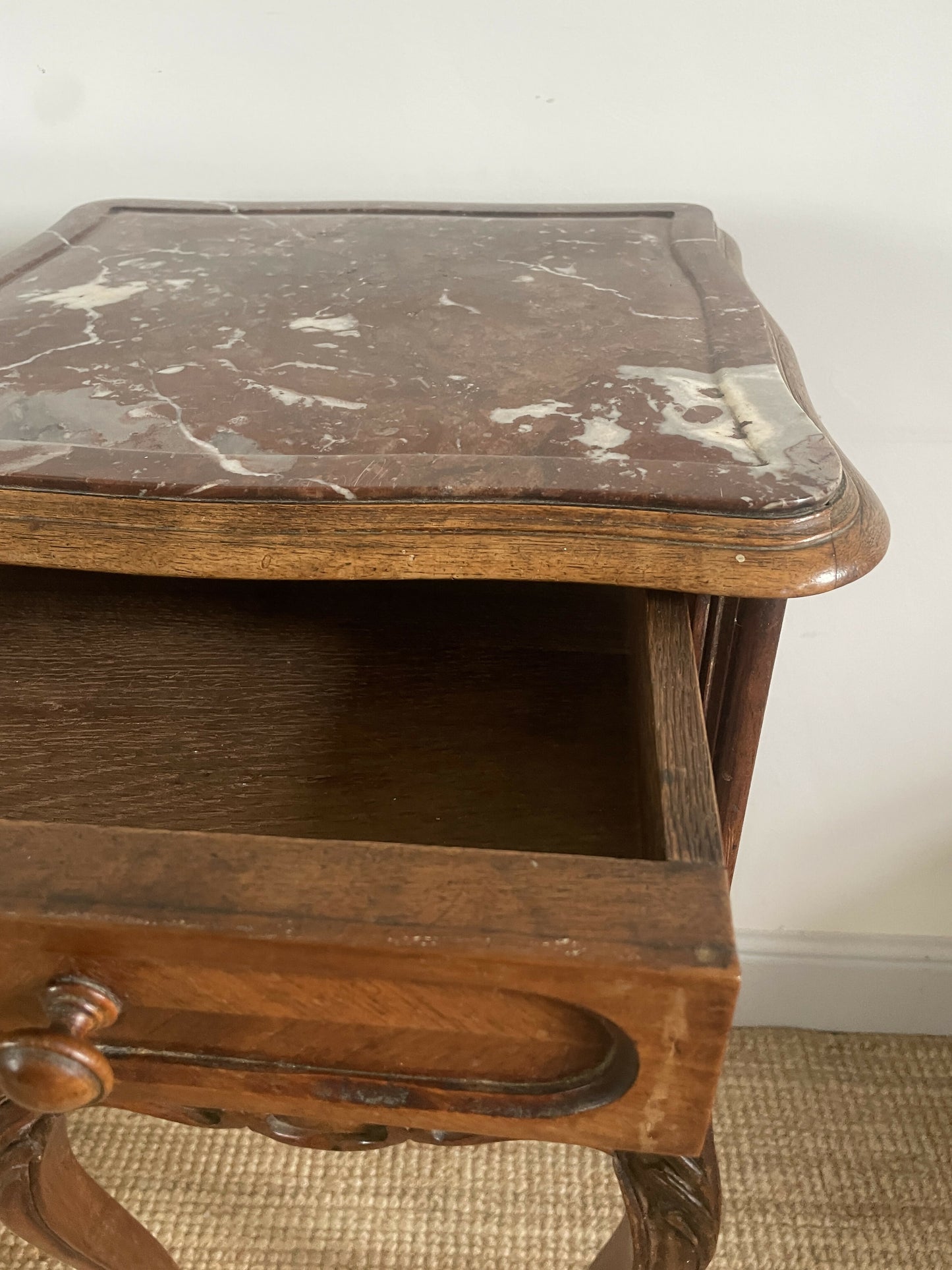 A near pair of antique French walnut and marble bedside tables